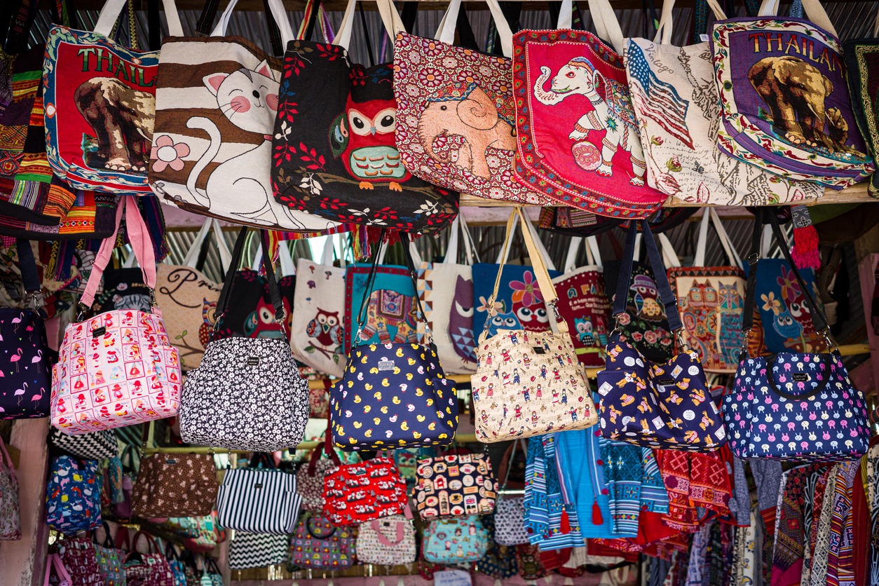 In a little town clothing shop, colorful handcrafted bags made by mountaineers dangle from the racks.
