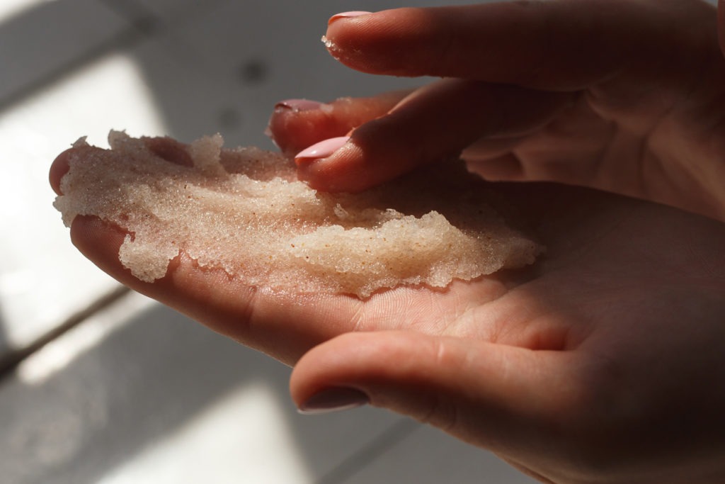 Oil salt scrub. Cosmetic surgery, hand peeling. Massage of female hands peeling preparation Spa and Wellness.