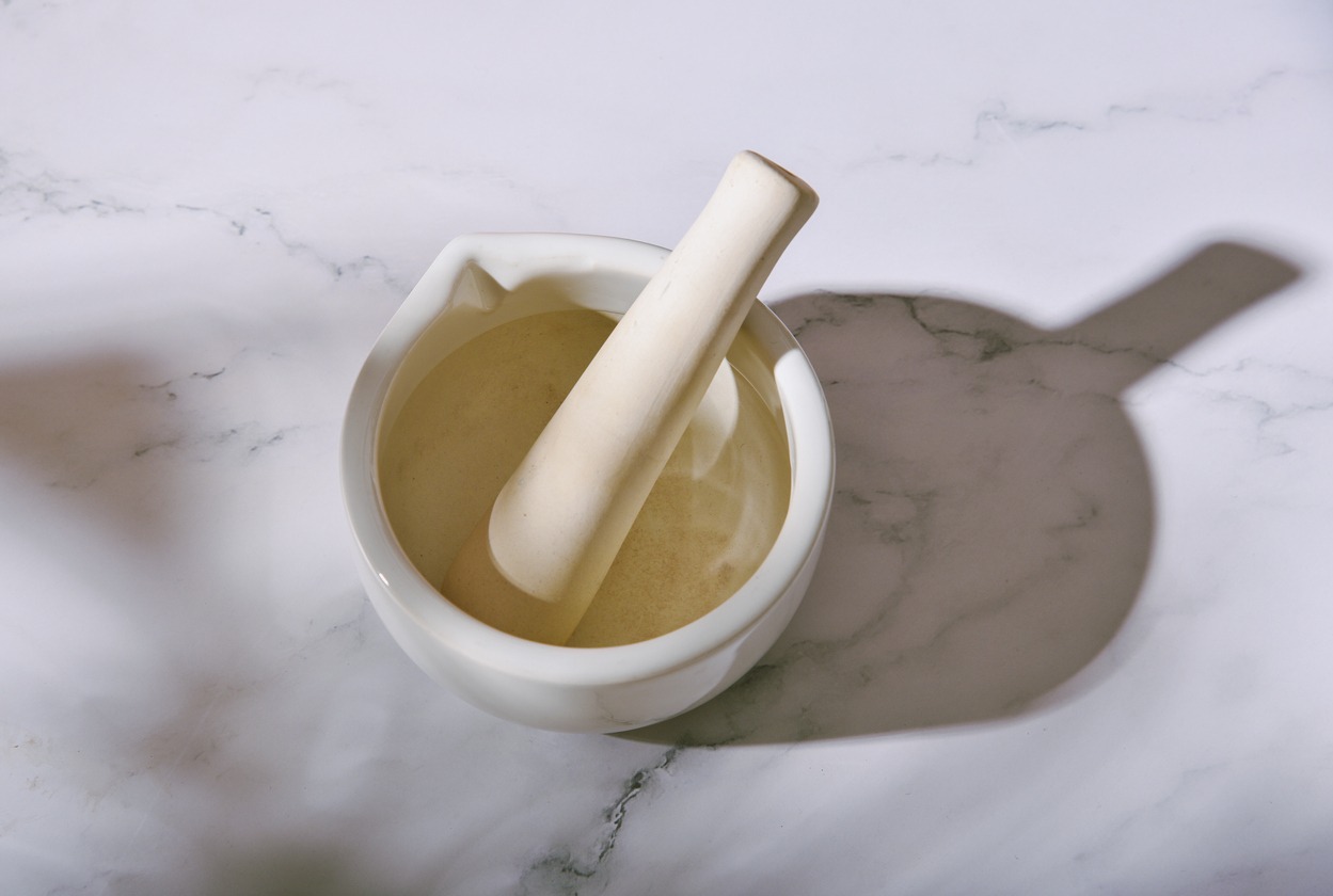 White porcelain mortar and pestle for mixing organic medicine in the pharmacy
