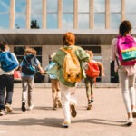 School children with backpacks walking to school