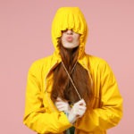 redhead-young-woman-in-yellow-waterproof-raincoat