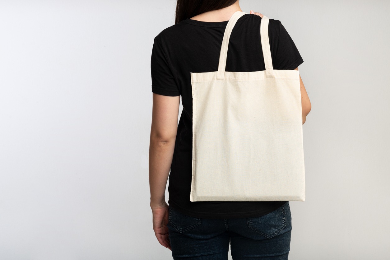 woman carrying a canvas tote bag