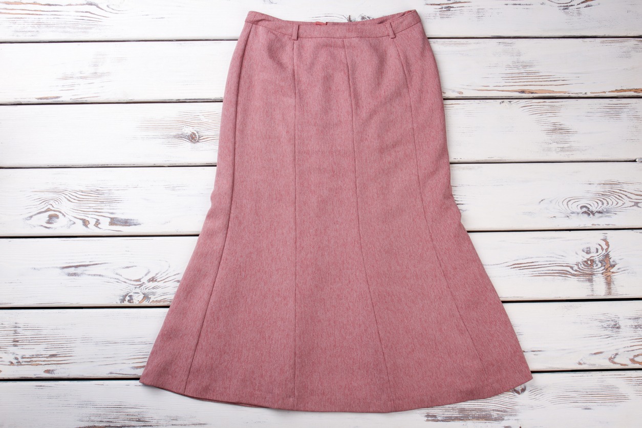 Classy female skirt, wooden background.