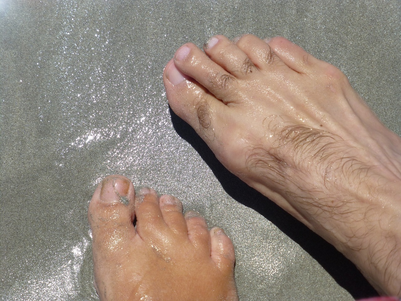 bare feet in sea sand