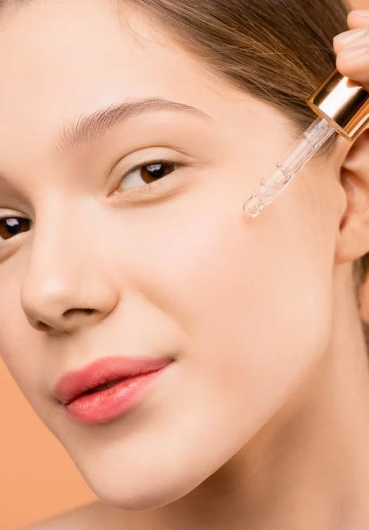 picture of a woman applying serum on her face