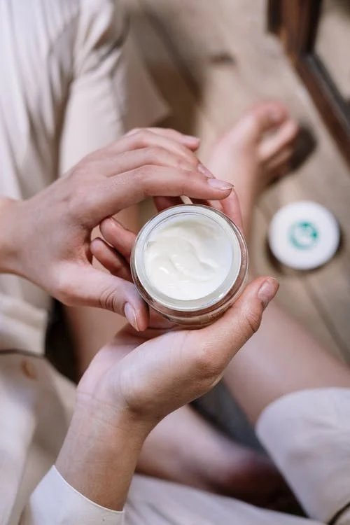 picture of a woman holding a cream