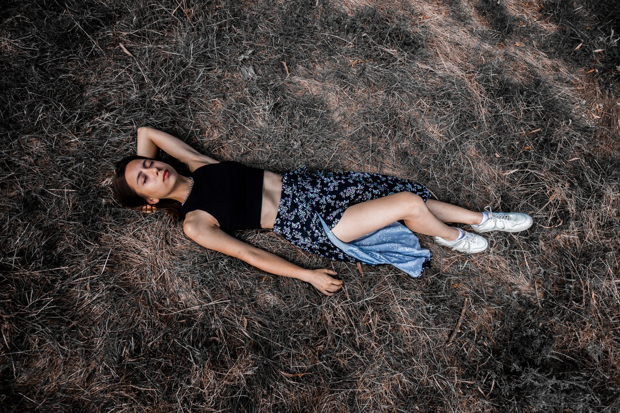 woman lying on the ground wearing a wrap skirt