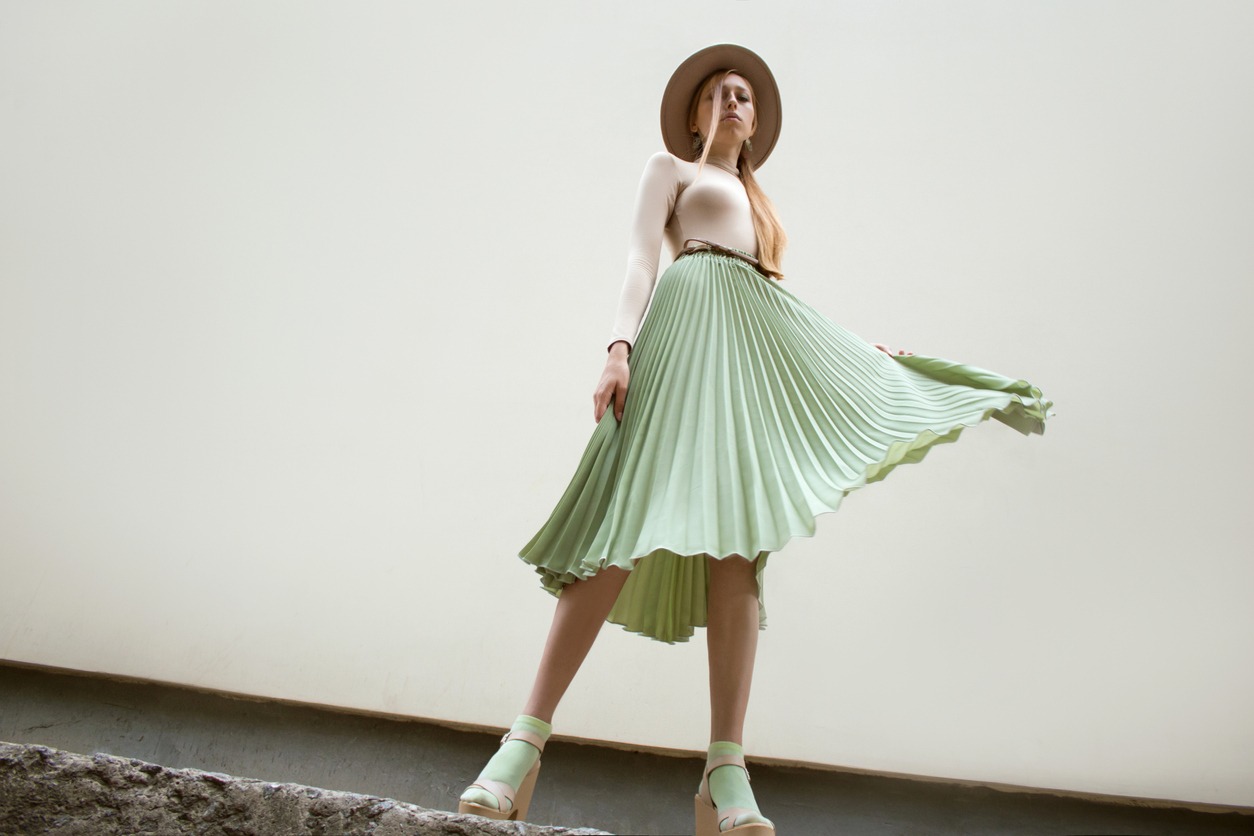 woman wearing a green pleated skirt