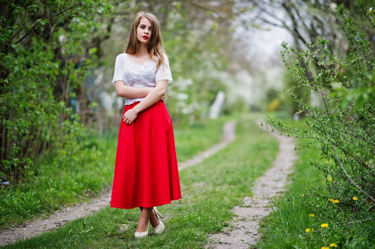 woman wearing a long, red A-line skirt