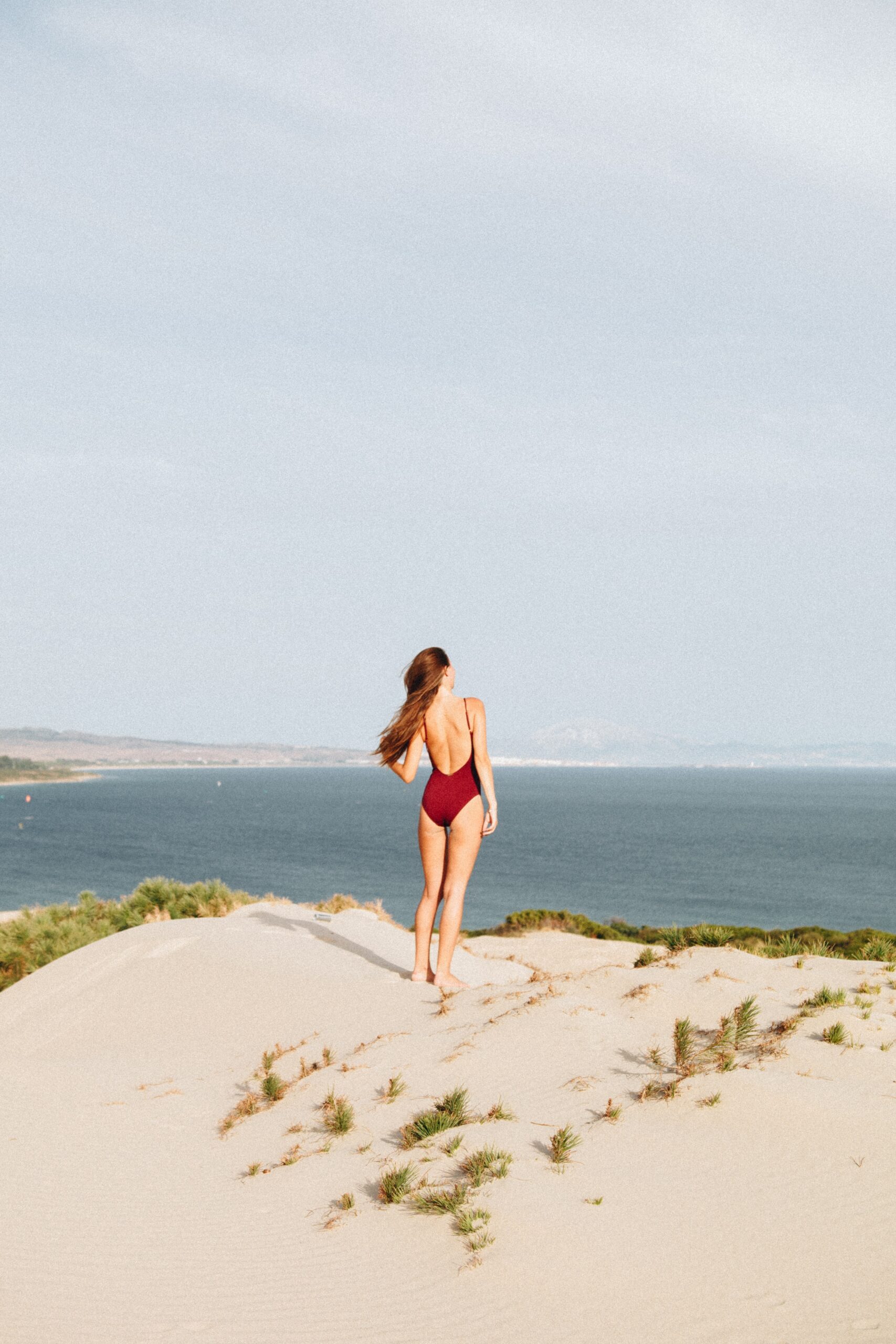 Woman in swimsuit standing on a cliff