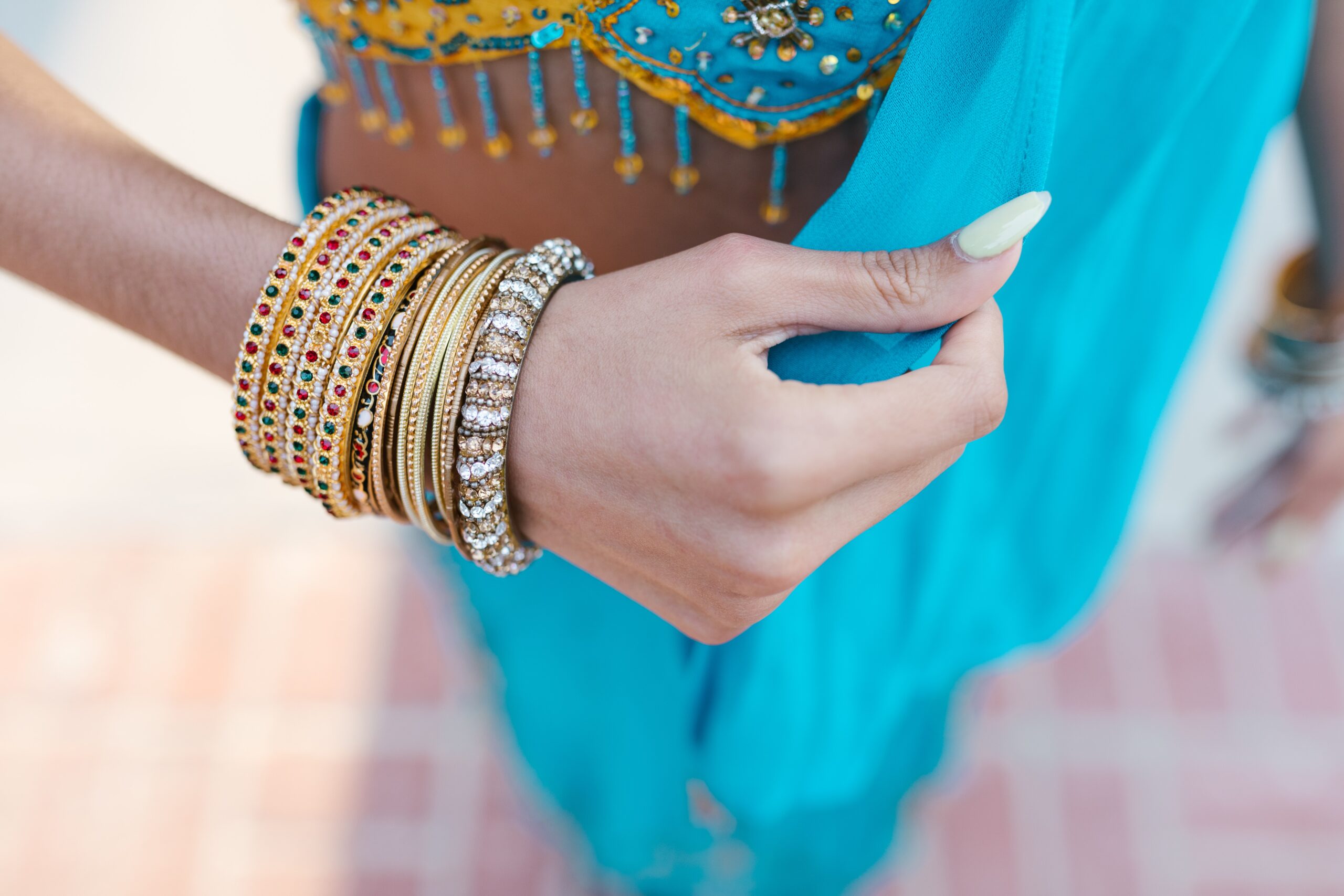 a person wearing gold and silver bracelets