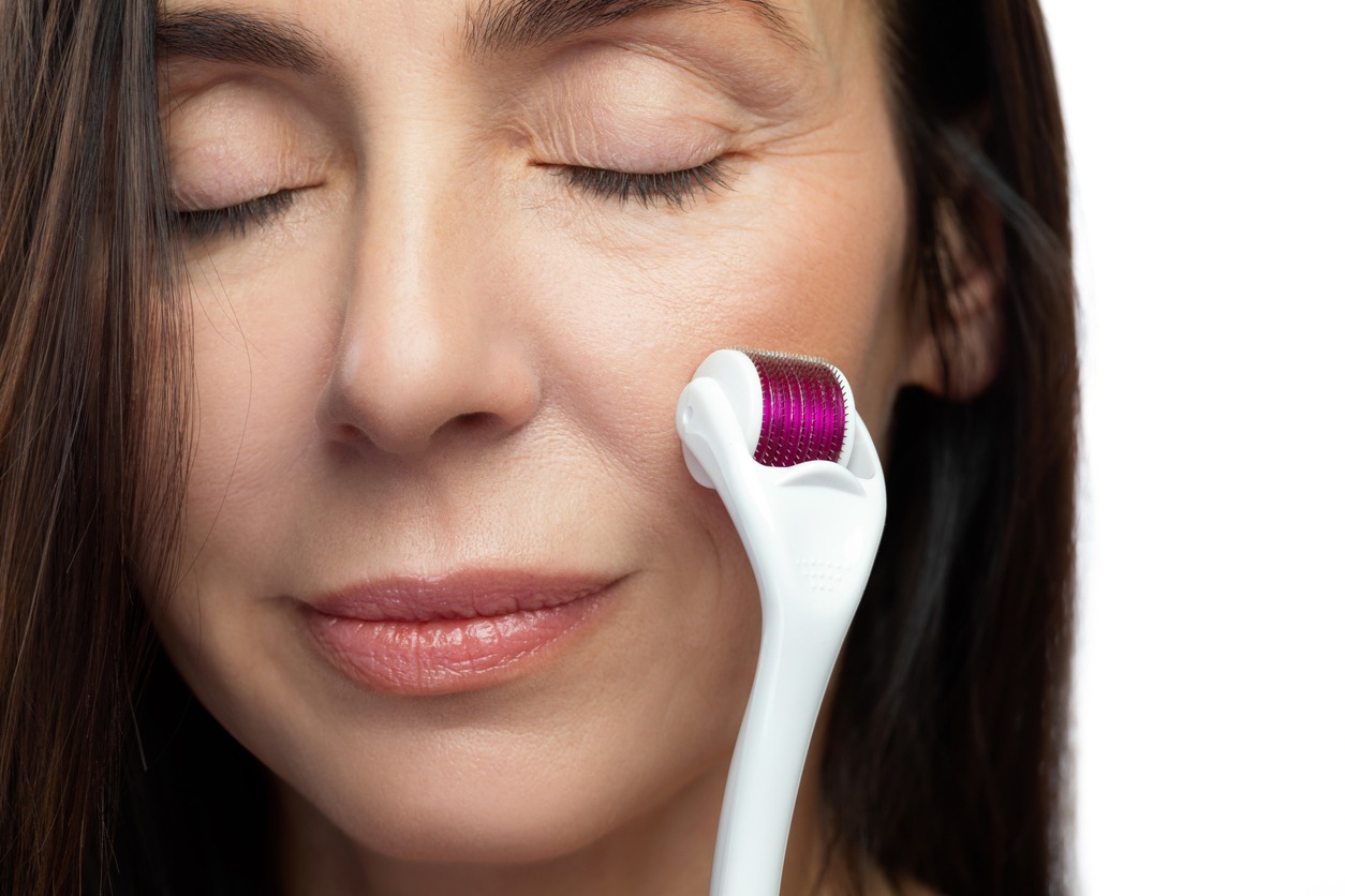 a-woman-with-closed-eyes-using-a-derma-roller-on-her-face