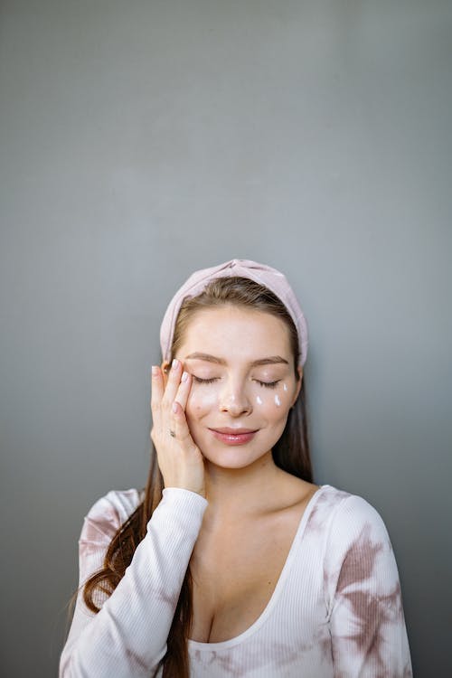 picture of a woman applying eye cream