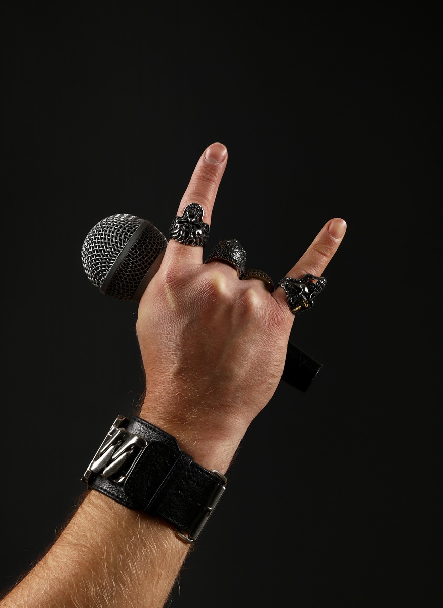 Man hand with microphone isolated on black