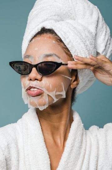 Woman-applying-toner-using-gauze-face-mask