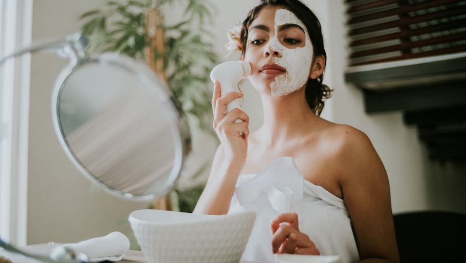 Woman-using-cleanser-while-massaging-face