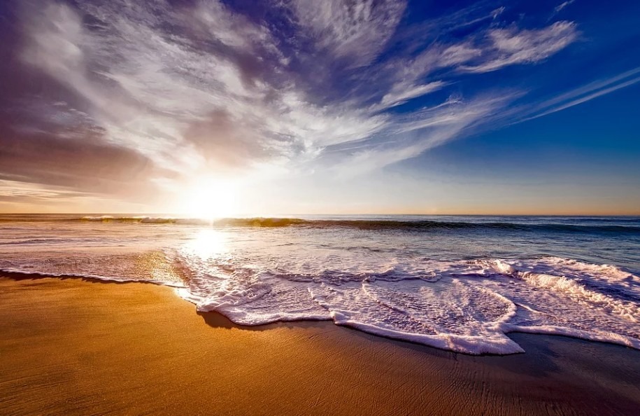 beach-sand-seawater-waves-sunset-clouds-sky
